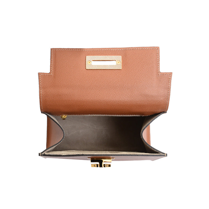 Open brown leather handbag with gold hardware and empty interior