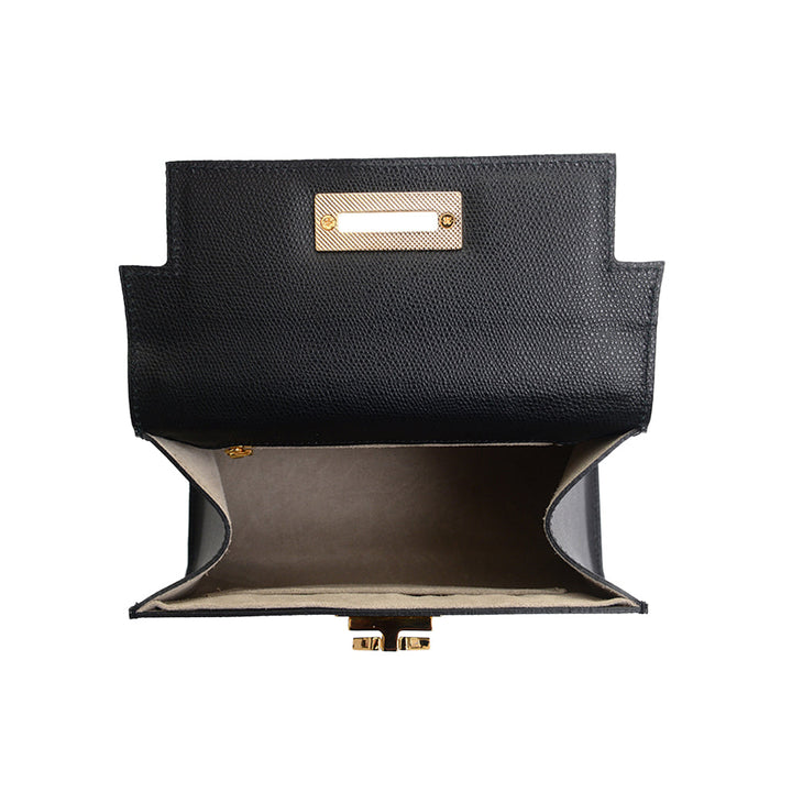 Black textured leather handbag with open flap revealing beige interior and gold hardware