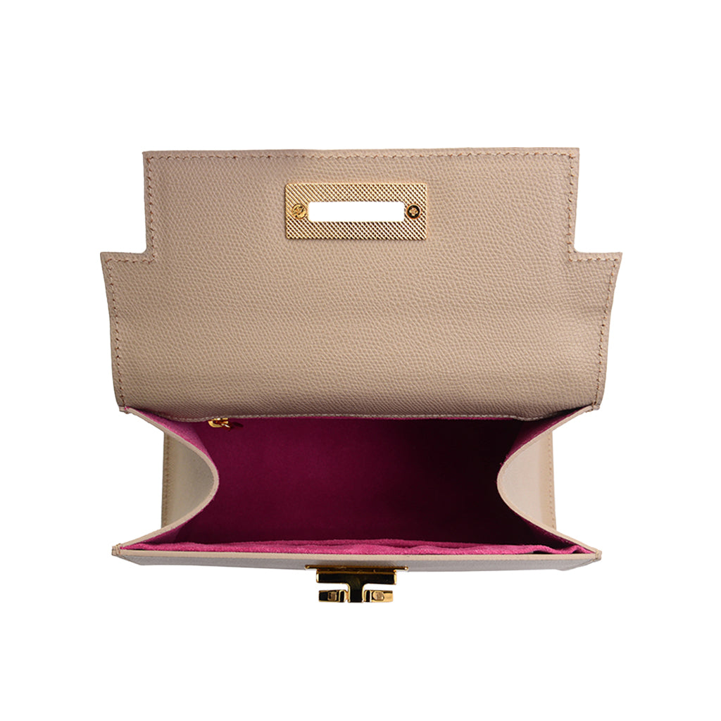 Open beige leather handbag with pink interior and gold clasp