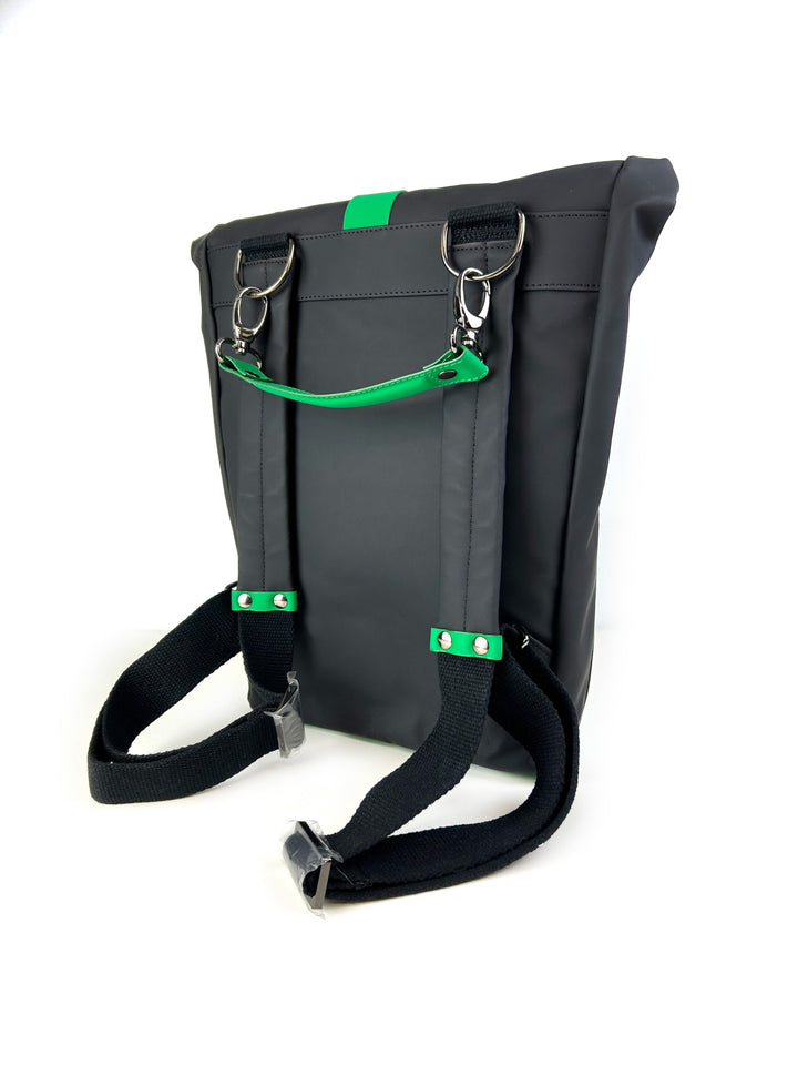 Gray backpack with green accents, showing adjustable straps and metal buckles, isolated on white background