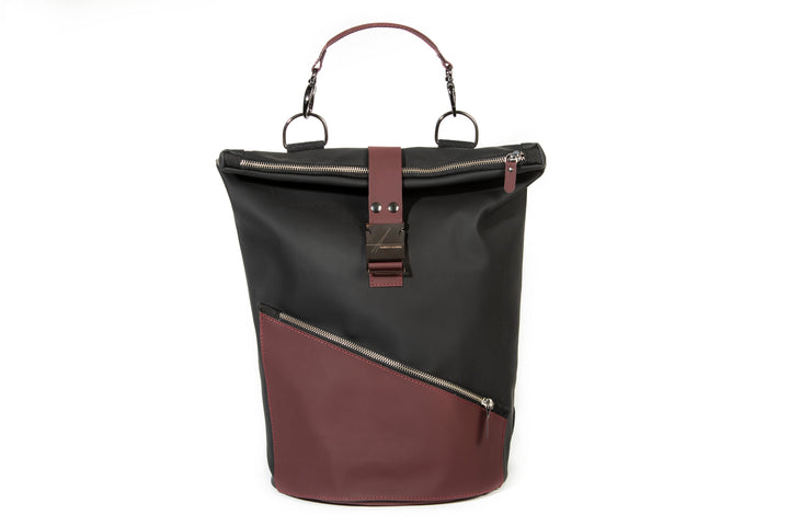 Black and maroon leather backpack with front zippers and a top handle against white background