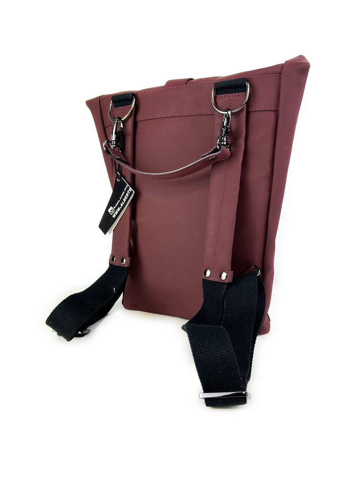 Maroon leather backpack with black adjustable shoulder straps and silver hardware