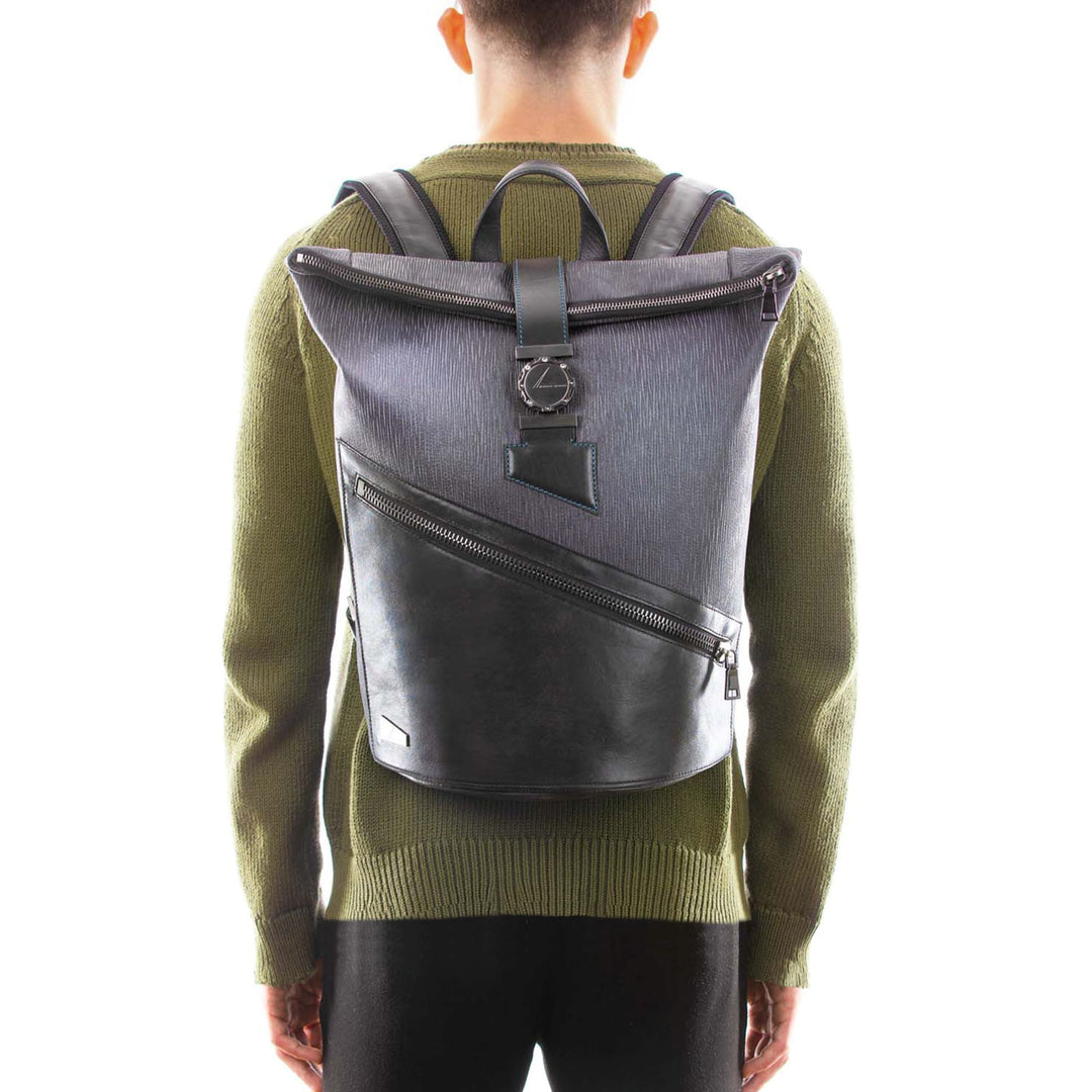Person wearing a stylish grey and black backpack with a unique zipper design