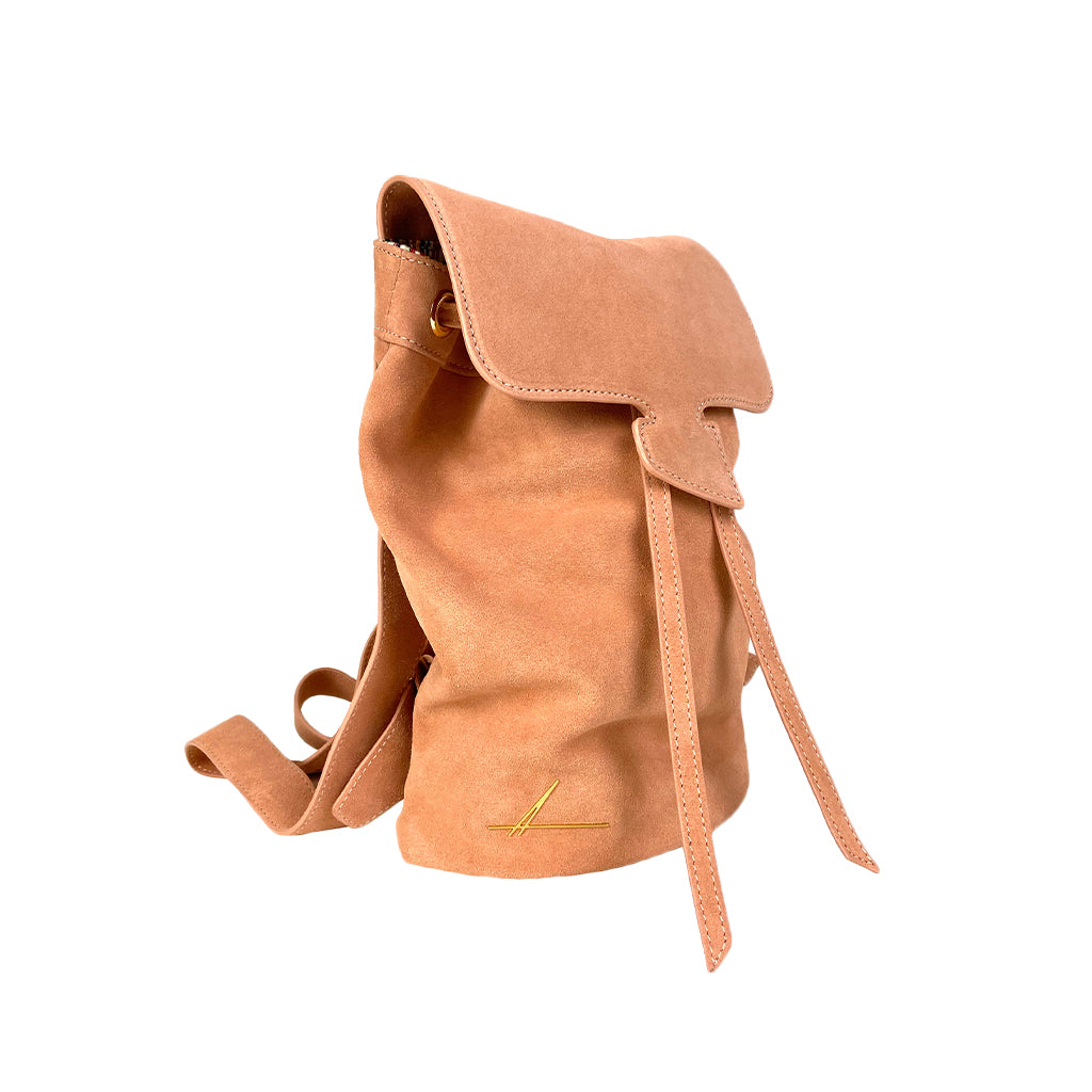 Tan leather backpack with a drawstring closure and flap, featuring a minimalist design and side strap, isolated on a white background