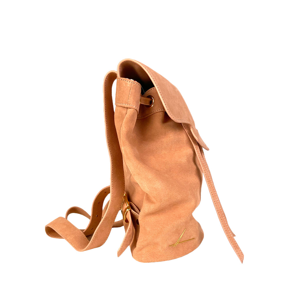Side view of a tan leather backpack with adjustable straps and a minimalist design