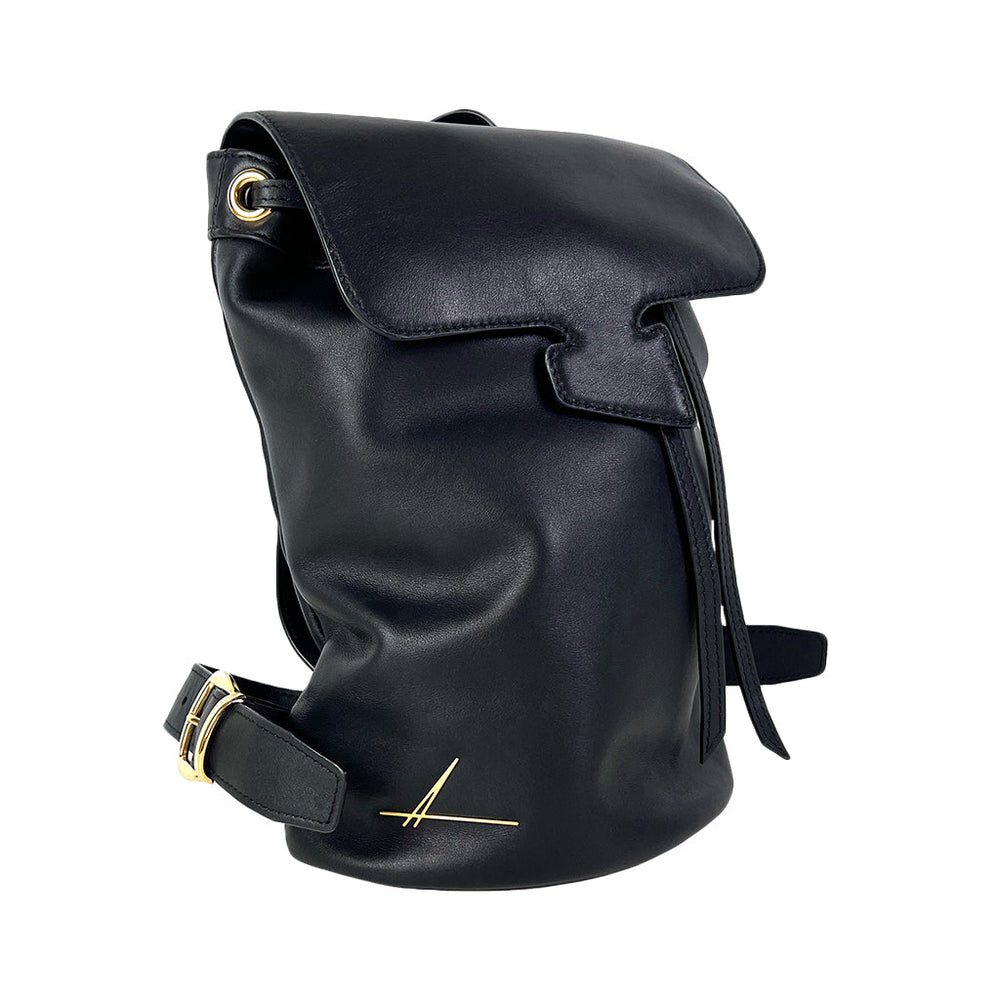Black leather backpack with gold buckle and minimalist design