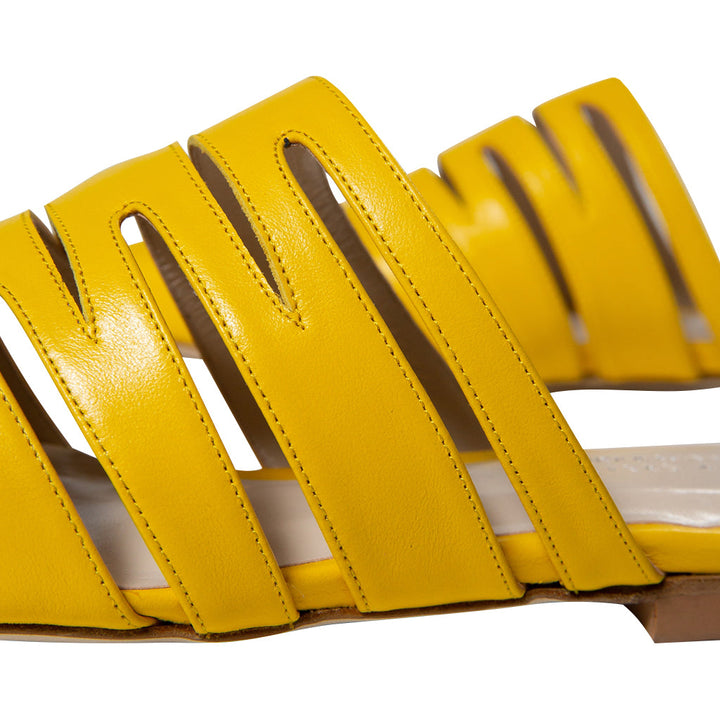 Yellow strappy leather sandal close-up showing detailed craftsmanship