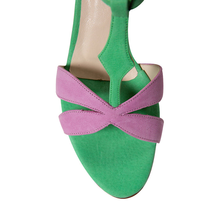 Top view of stylish green and pink suede sandal with crossover straps