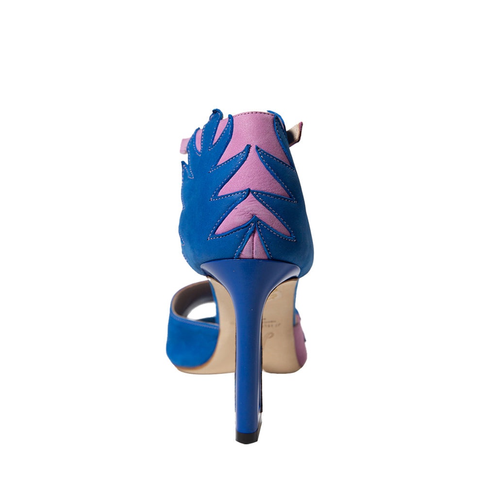 Pink and blue high-heeled sandal with leaf pattern on white background