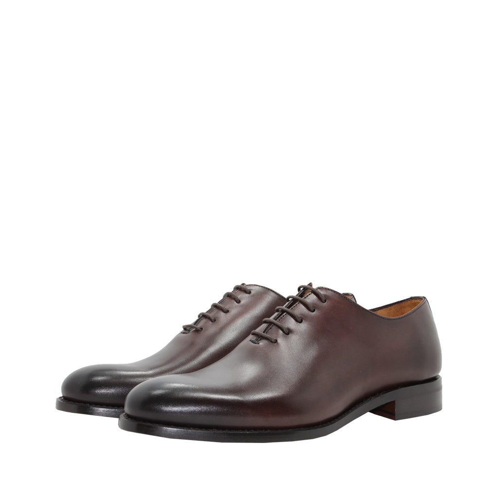 Elegant brown leather oxford shoes with laces on a white background