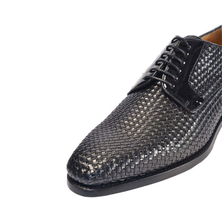 Woven black leather oxford shoe close-up