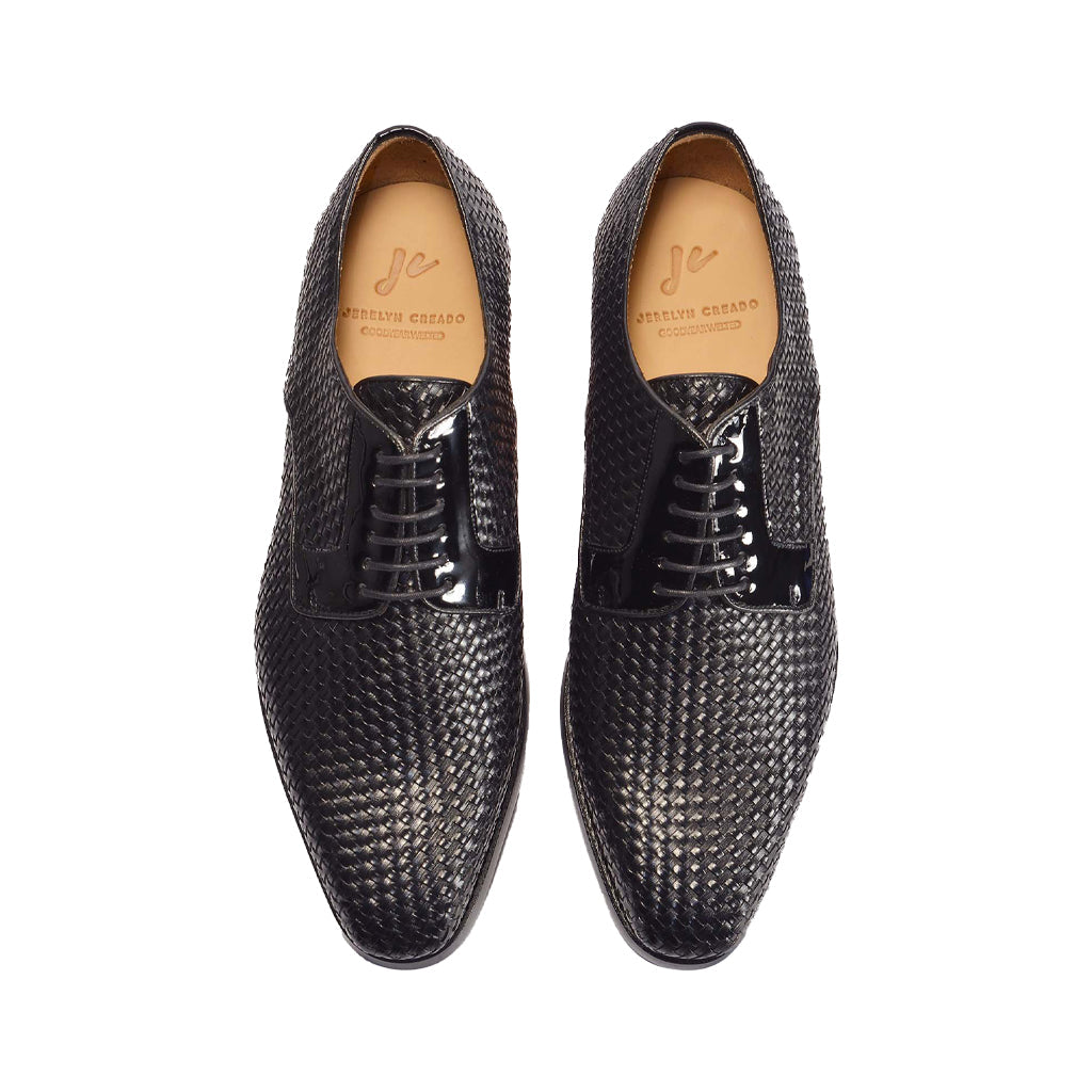 Black woven leather dress shoes with laces, by designer Santoni, on white background