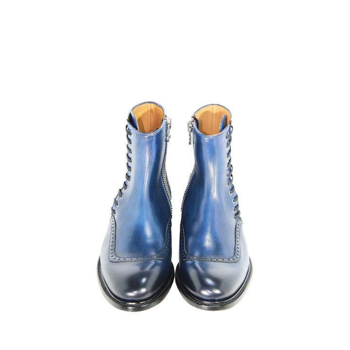 Blue leather lace-up ankle boots with side zippers on a white background