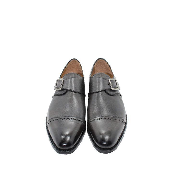 Pair of black leather dress shoes with buckle detail