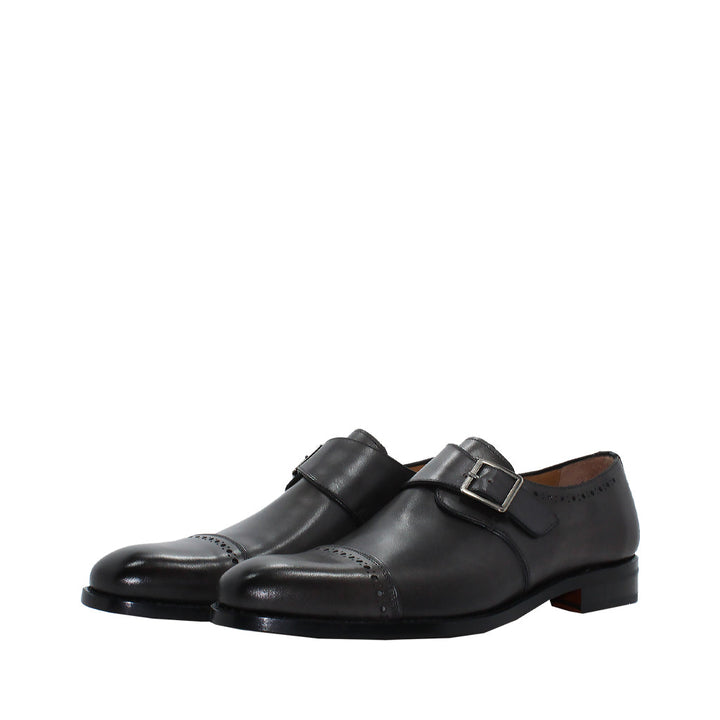 Black leather monk strap dress shoes with buckle detail