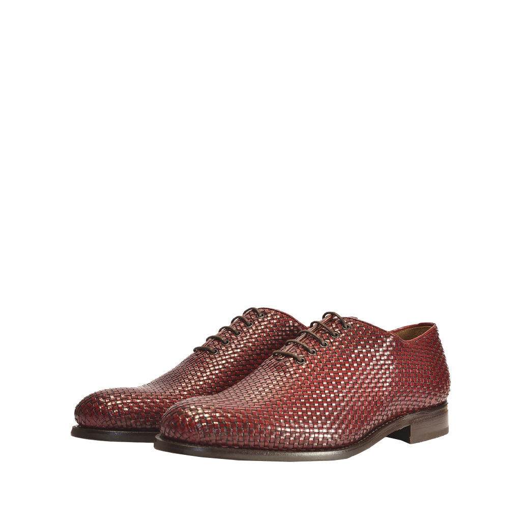 Stylish brown woven leather dress shoes on white background