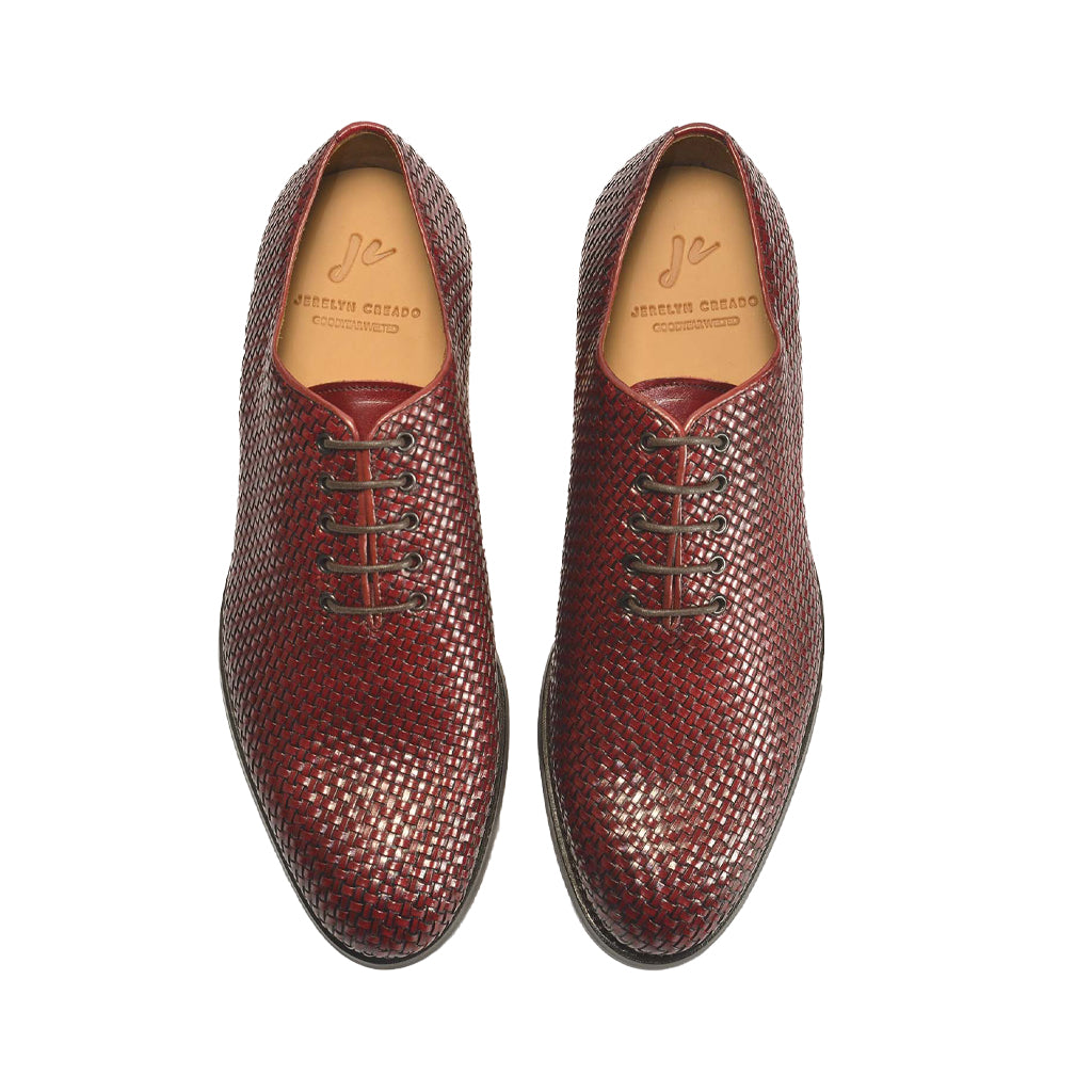 Burgundy woven leather dress shoes with lace-up design, displayed from top view