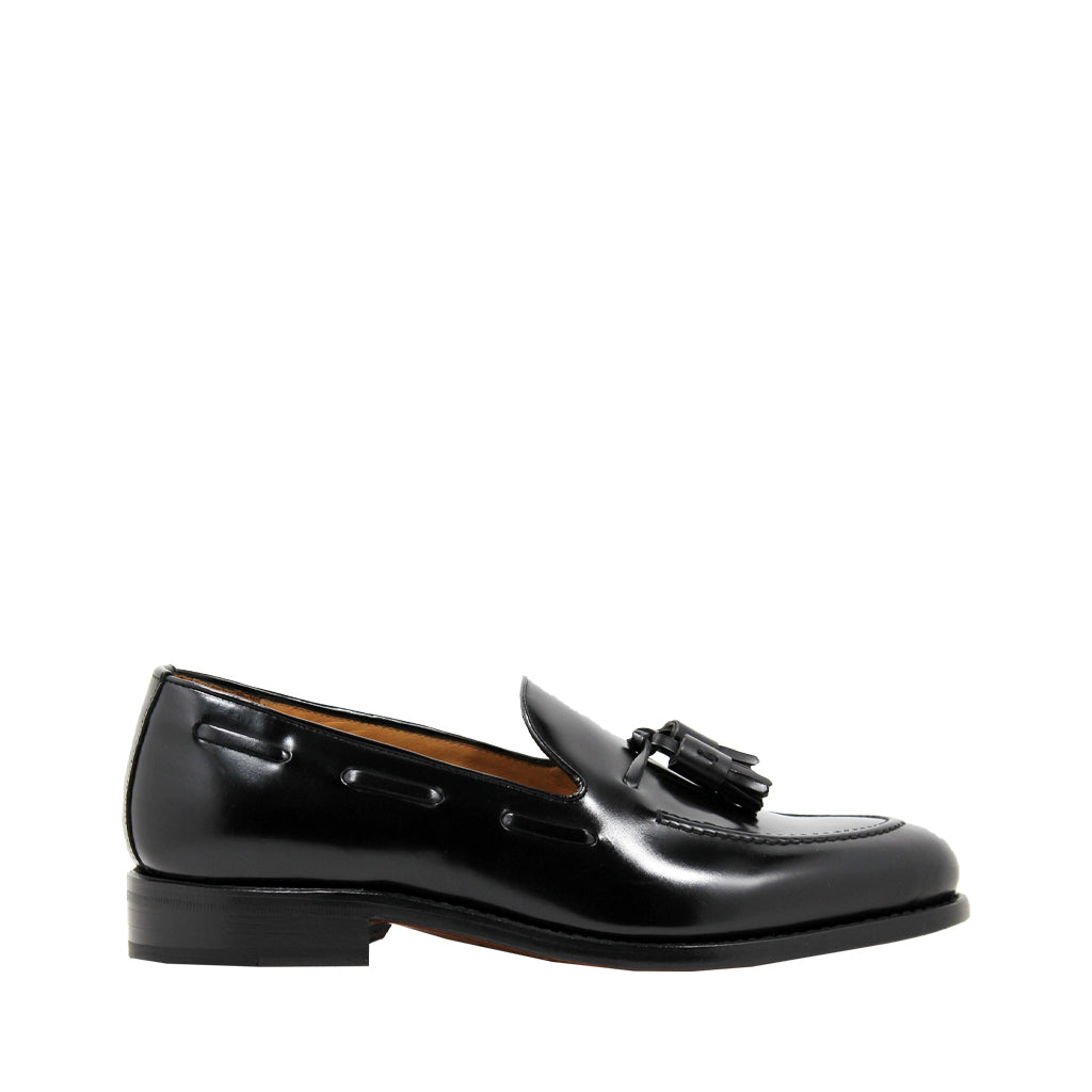 Black leather loafer with tassels on a white background