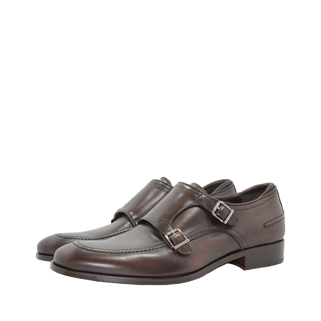 Brown leather monk strap dress shoes on a white background