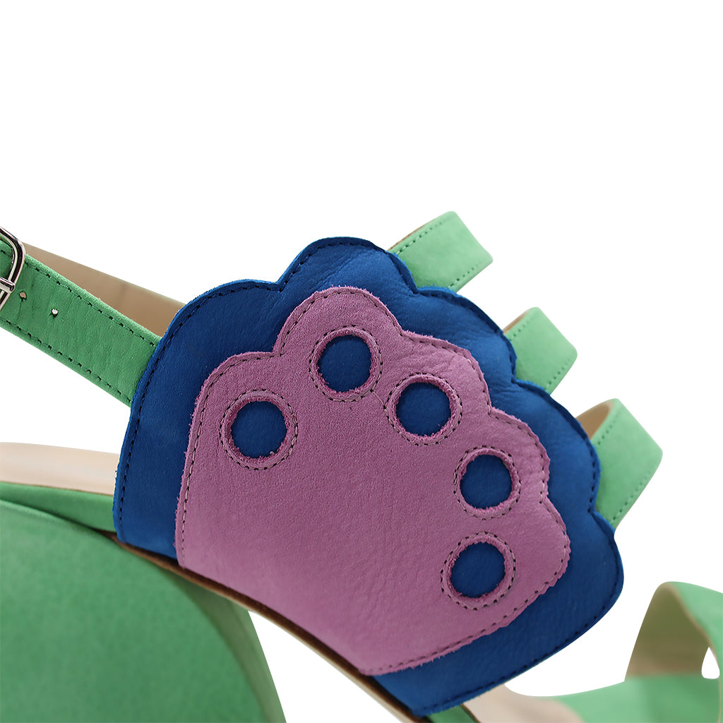 Green sandal with colorful pink and blue paw design on strap