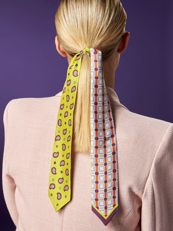 Woman with a ponytail tied using colorful neckties against purple background