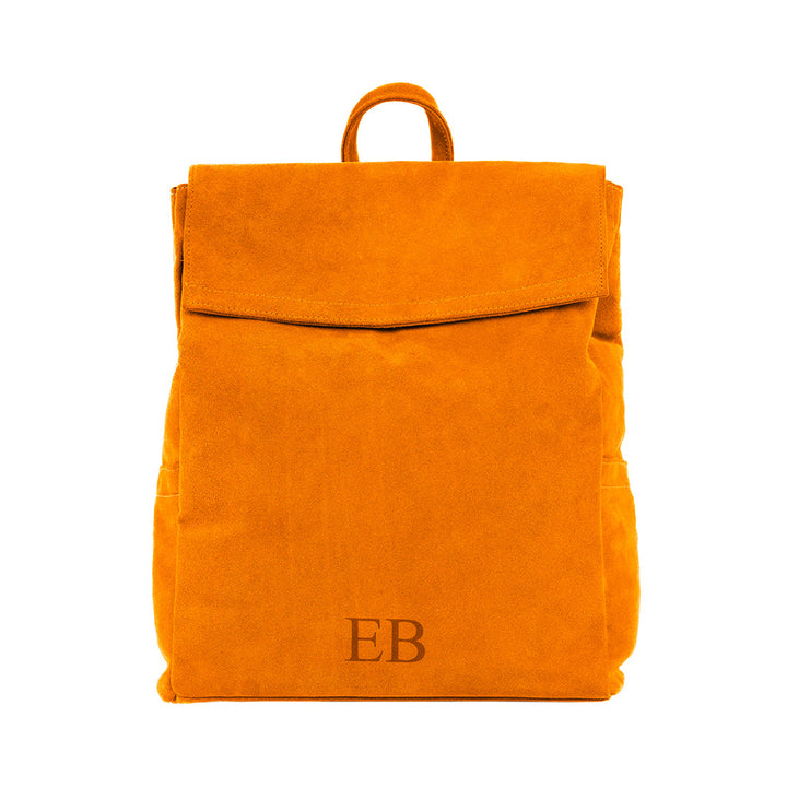 Bright orange suede backpack with a top flap and initials EB on the front