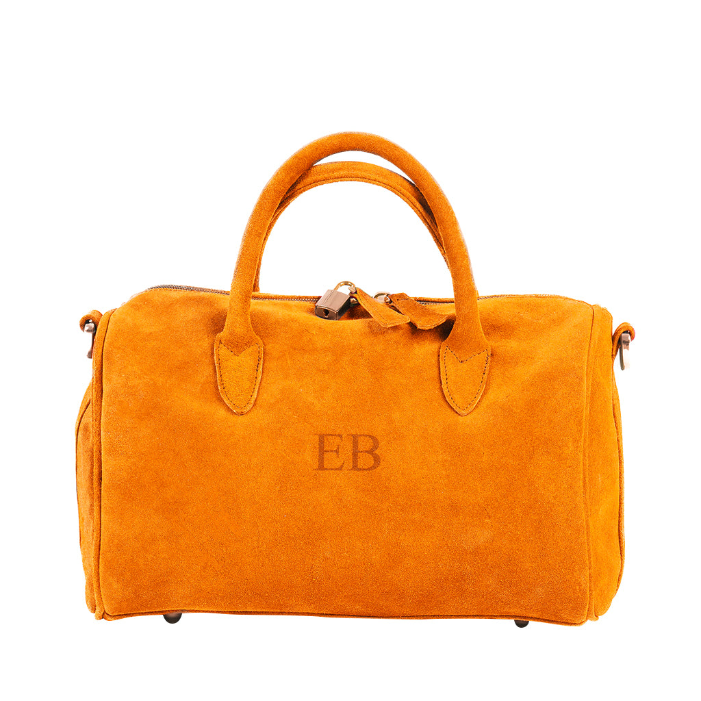 Orange suede handbag with initials EB embossed on the front, featuring dual handles and a zippered top closure