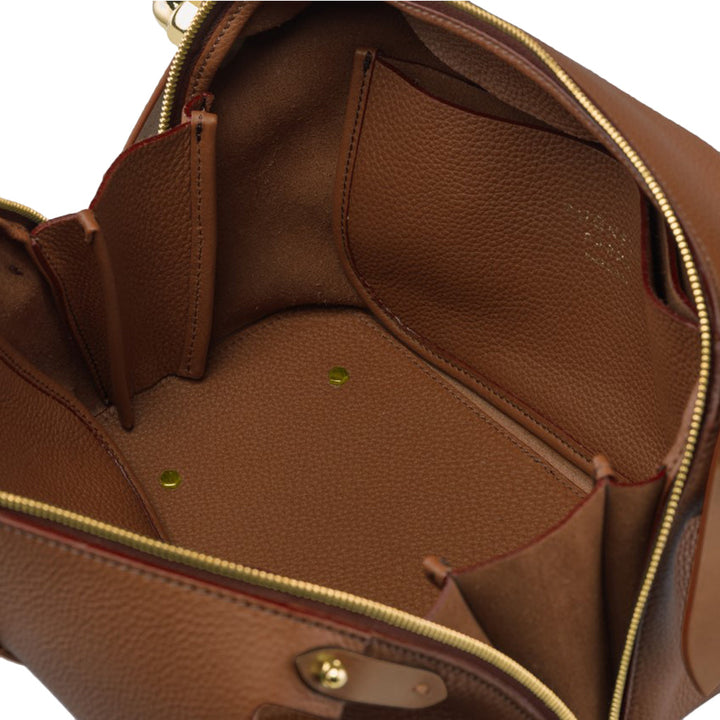 Brown leather bag interior with multiple pockets and gold zipper