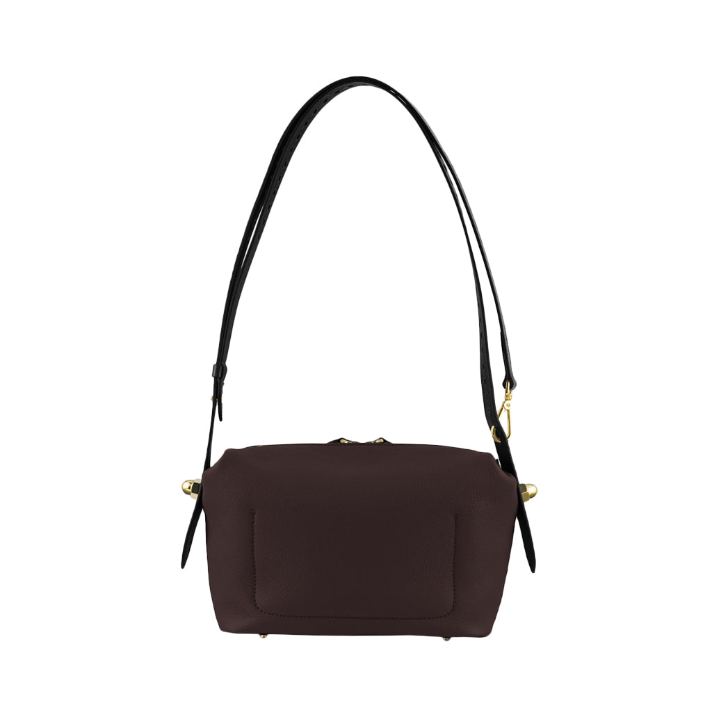 Brown leather handbag with black shoulder strap and gold accents