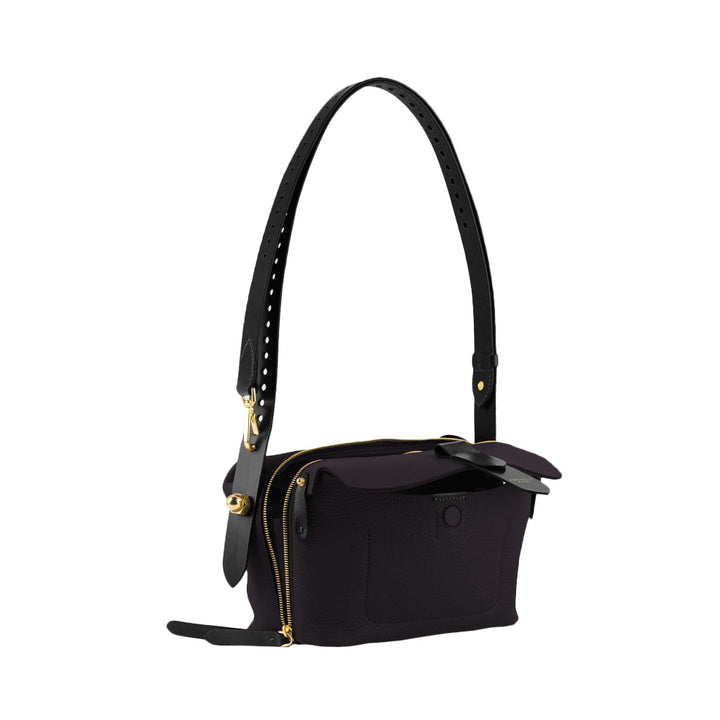 Elegant black leather handbag with gold zippers and adjustable strap