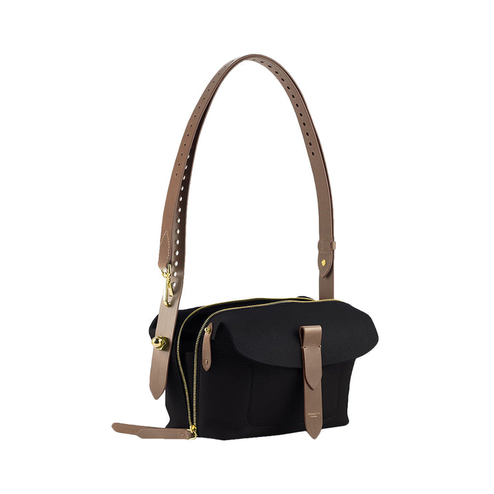 Black and tan leather shoulder bag with gold zipper and buckle accents