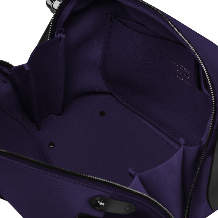 Open purple leather handbag showing interior compartments and zipper