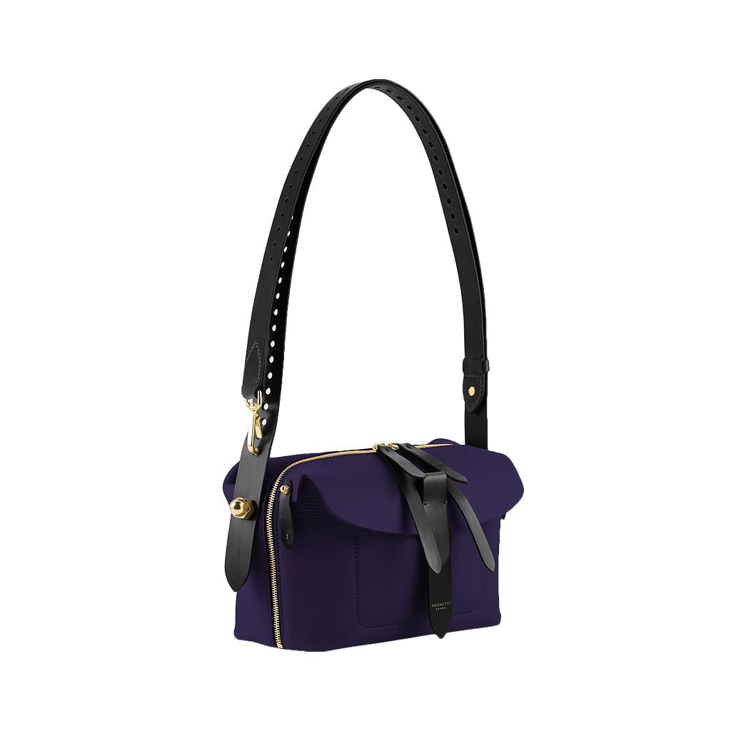 Elegant purple leather handbag with black adjustable strap and gold hardware