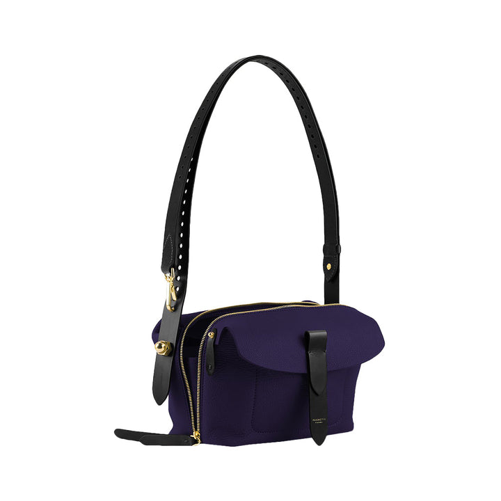 Purple leather handbag with black adjustable strap and gold zipper