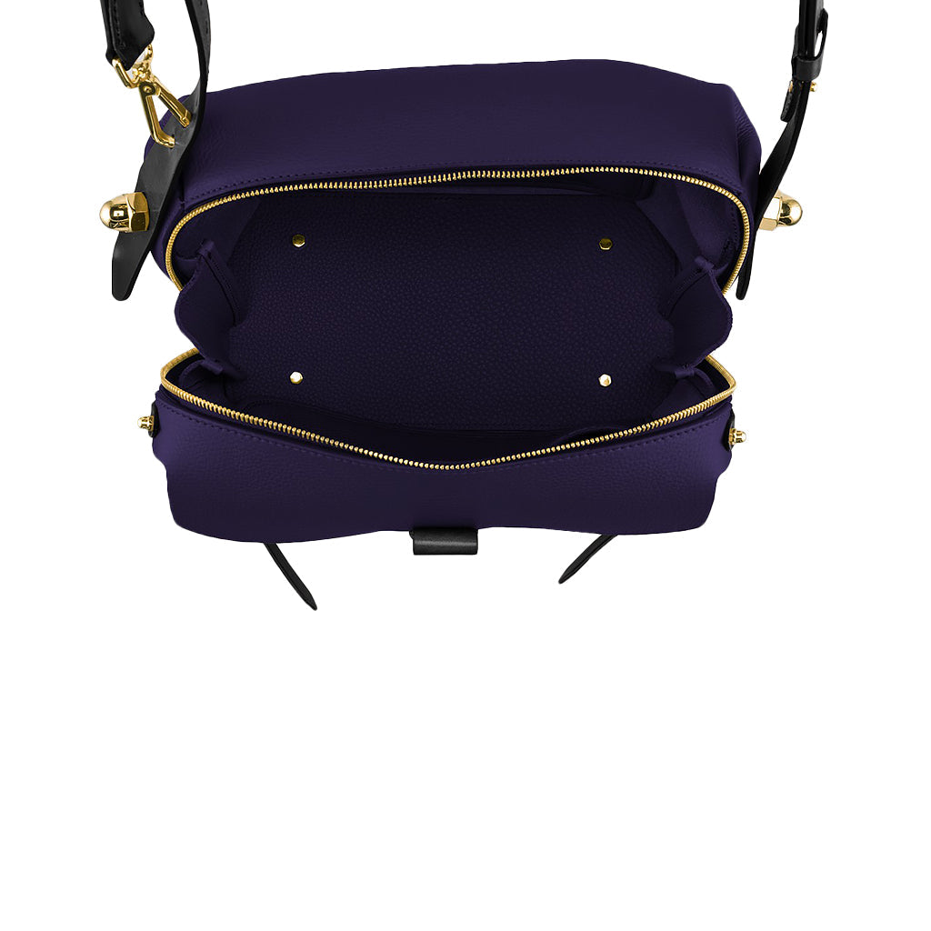 Purple open handbag with gold zippers and black straps on white background