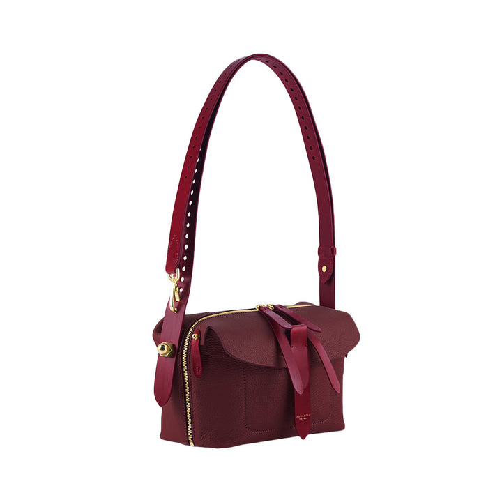 Elegant maroon leather handbag with adjustable strap and gold hardware