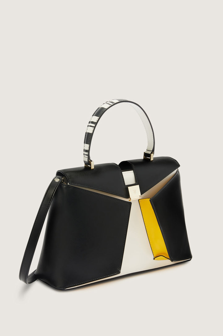 Black, white, and yellow geometric-patterned handbag with a short strap