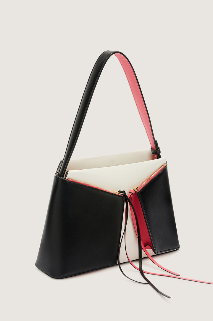 Stylish black and red leather handbag with long strap and zip closure