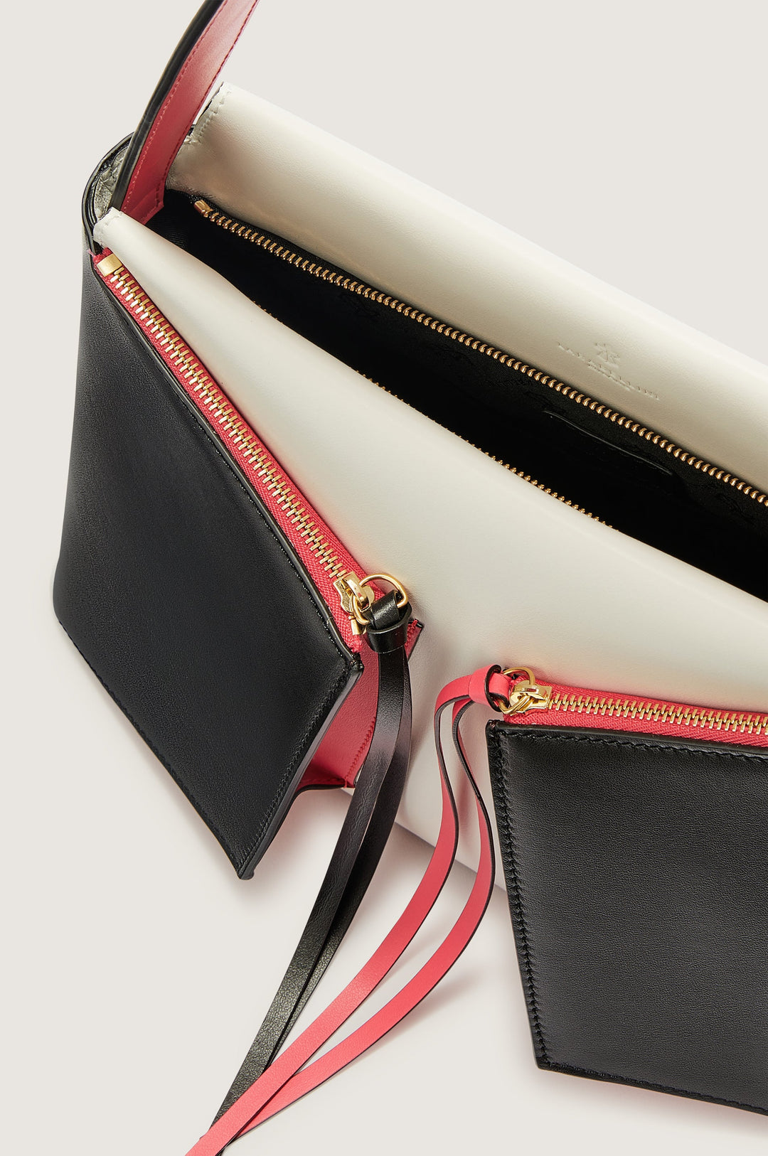 Elegant black and red clutch bag with gold zippers and multiple compartments