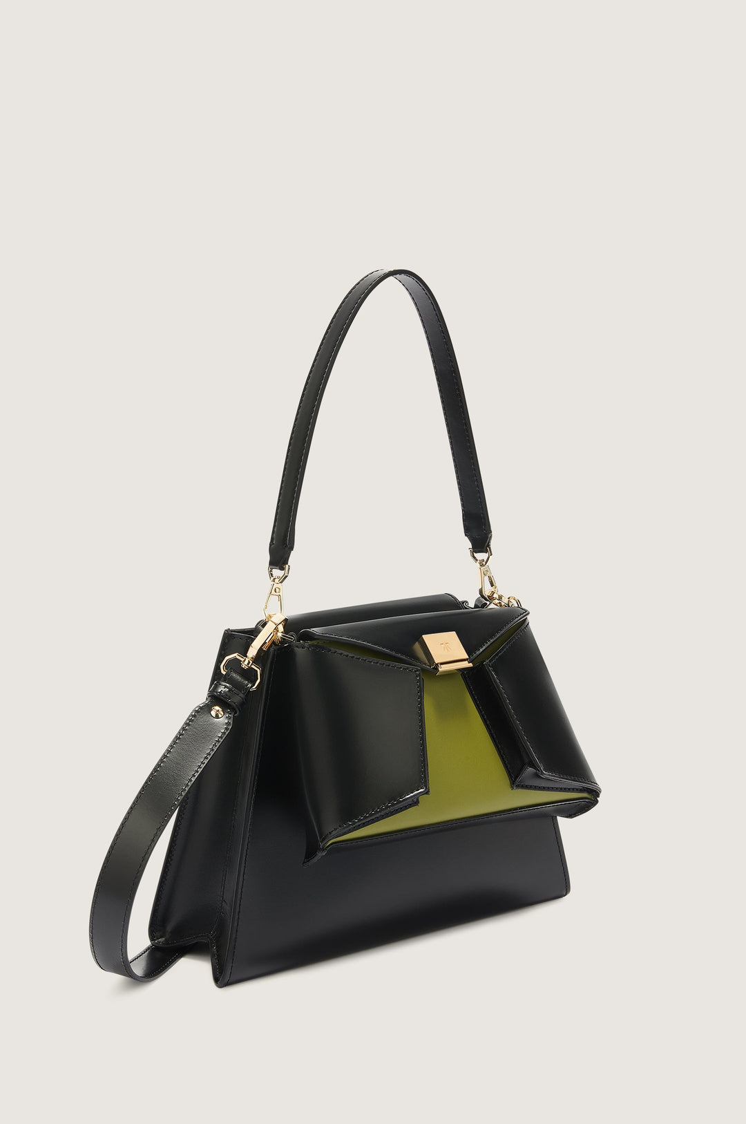 Stylish black leather handbag with gold clasp and green interior detailing