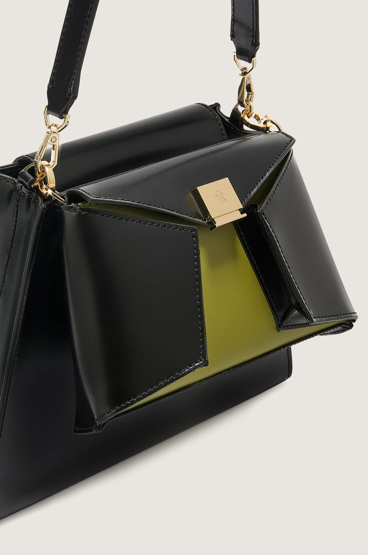 Black and olive green designer handbag with gold hardware and sophisticated detailing