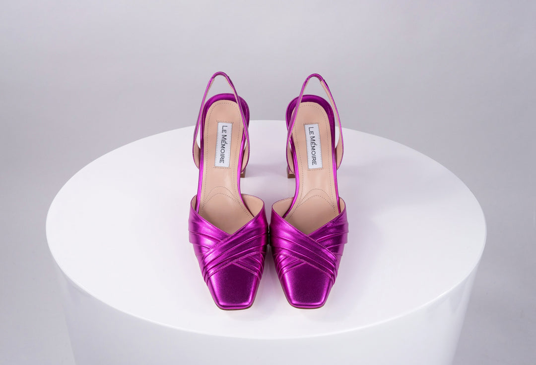 Magenta high heel slingback shoes on white pedestal