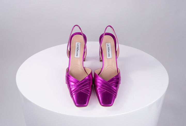 Magenta high heel slingback shoes on white pedestal