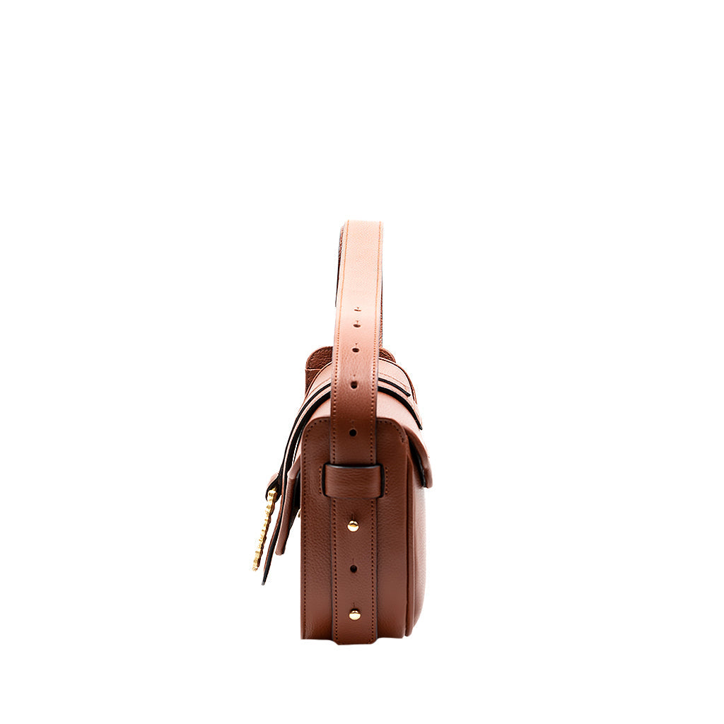 Side view of a stylish brown leather shoulder bag with adjustable strap