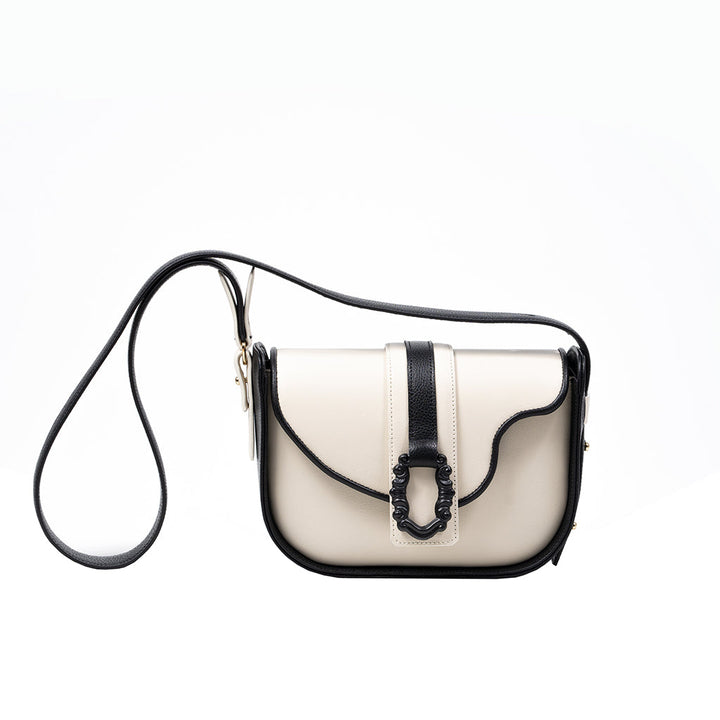 Elegant black and white leather crossbody bag with decorative buckle