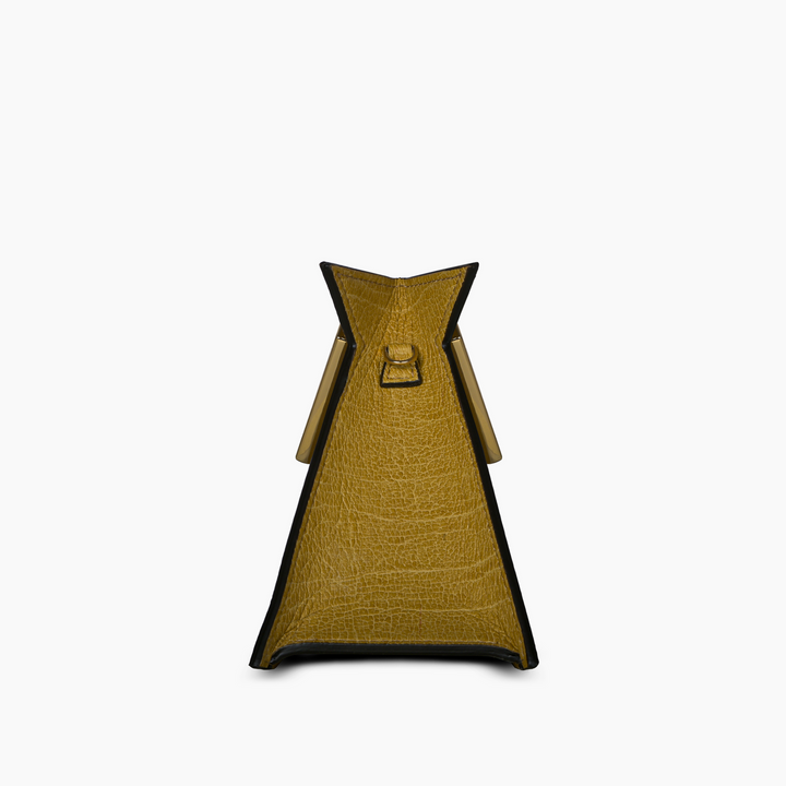 Side view of a yellow textured leather handbag with a triangular shape and handle