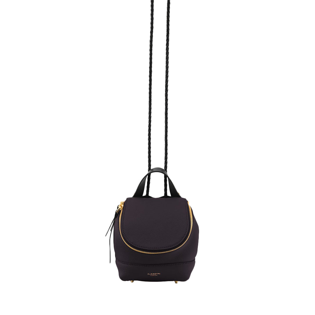 Elegant black leather backpack with gold zipper detail suspended by straps