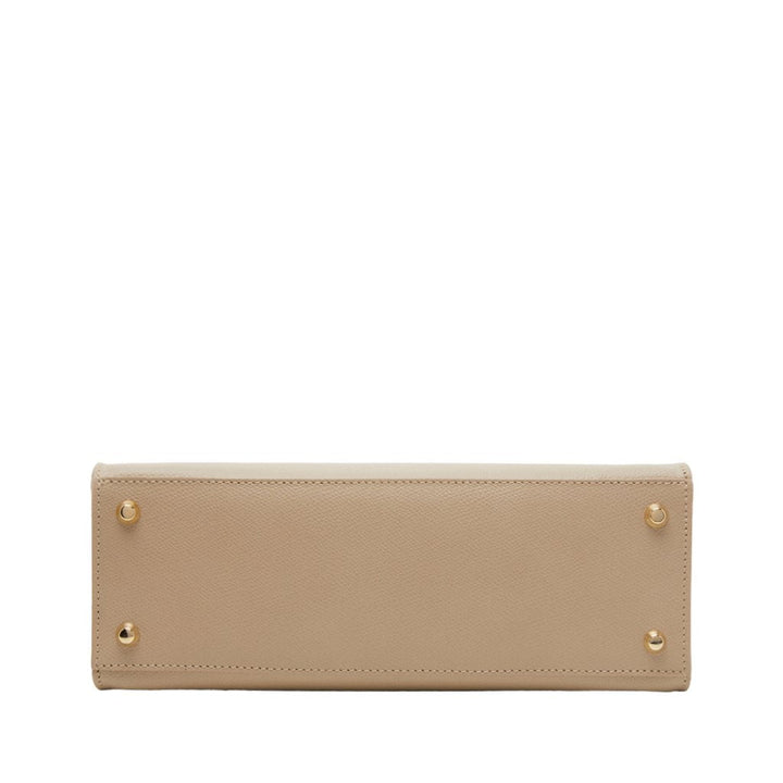 Beige leather handbag bottom view with gold studs