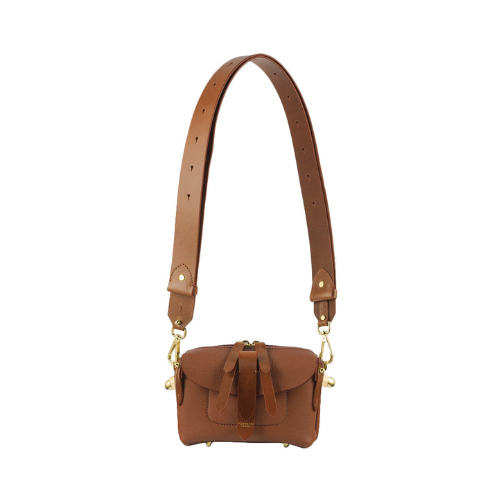 Brown leather crossbody bag with adjustable strap and buckle accents