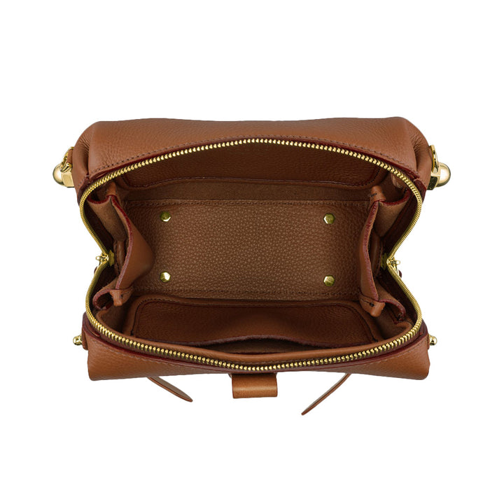 Open brown leather handbag showing spacious interior with gold hardware